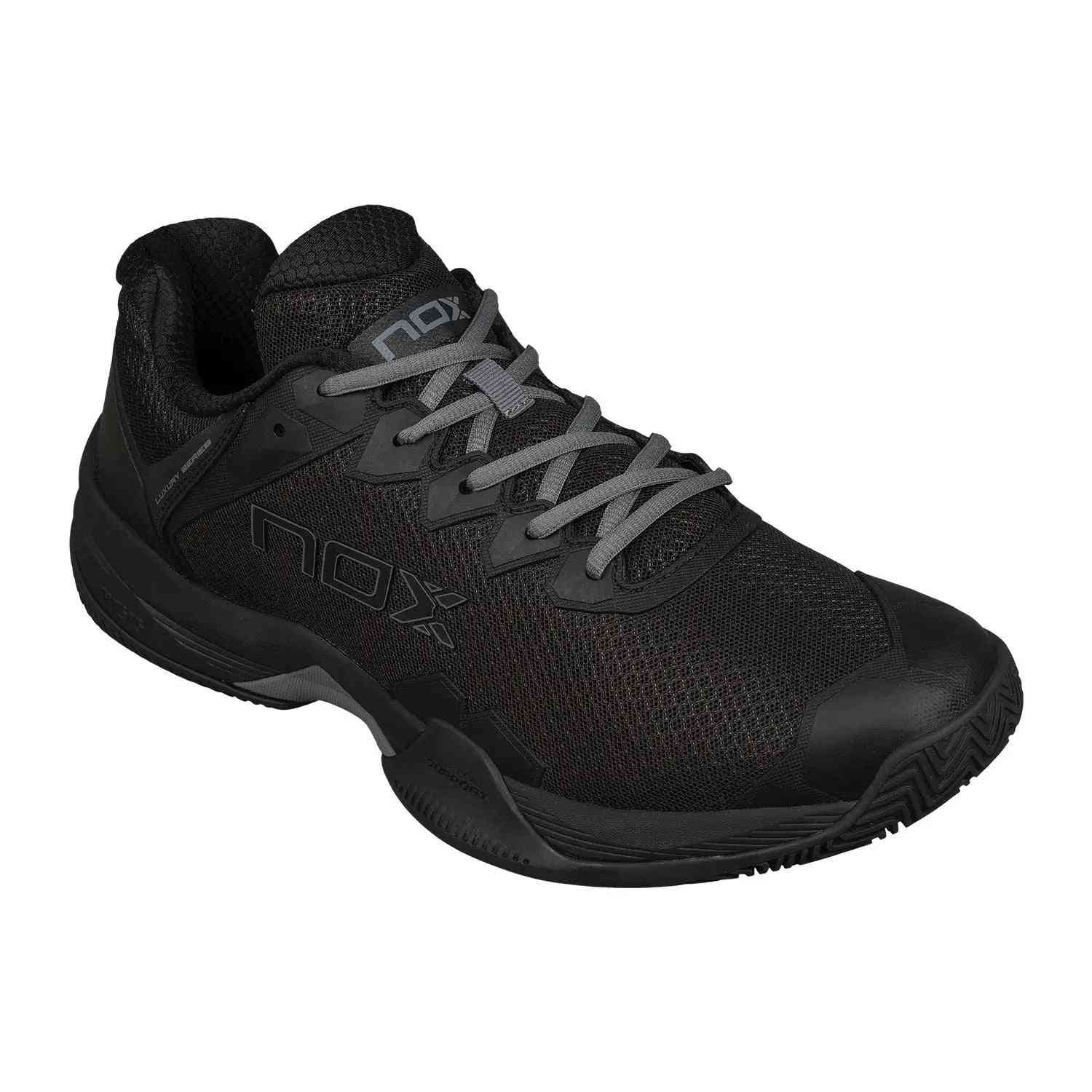 Angled view of Nox ML10 Hexa Calmlhexblgs Black padel shoe highlighting durable outsole and sleek all-black design for court stability.
