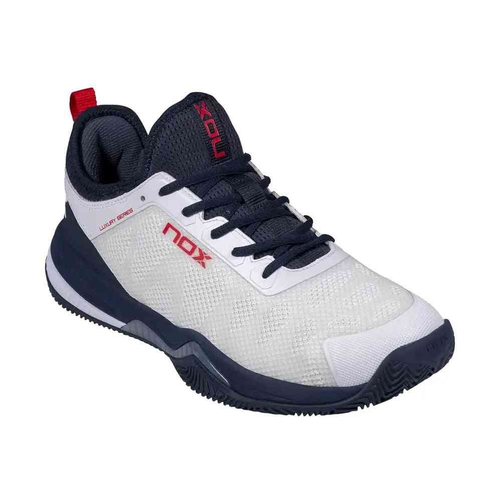 Angled front view of Nox Lux Nerbo White Navy Blue Caluxnerwhna padel shoe highlighting reinforced toe and lace-up design.