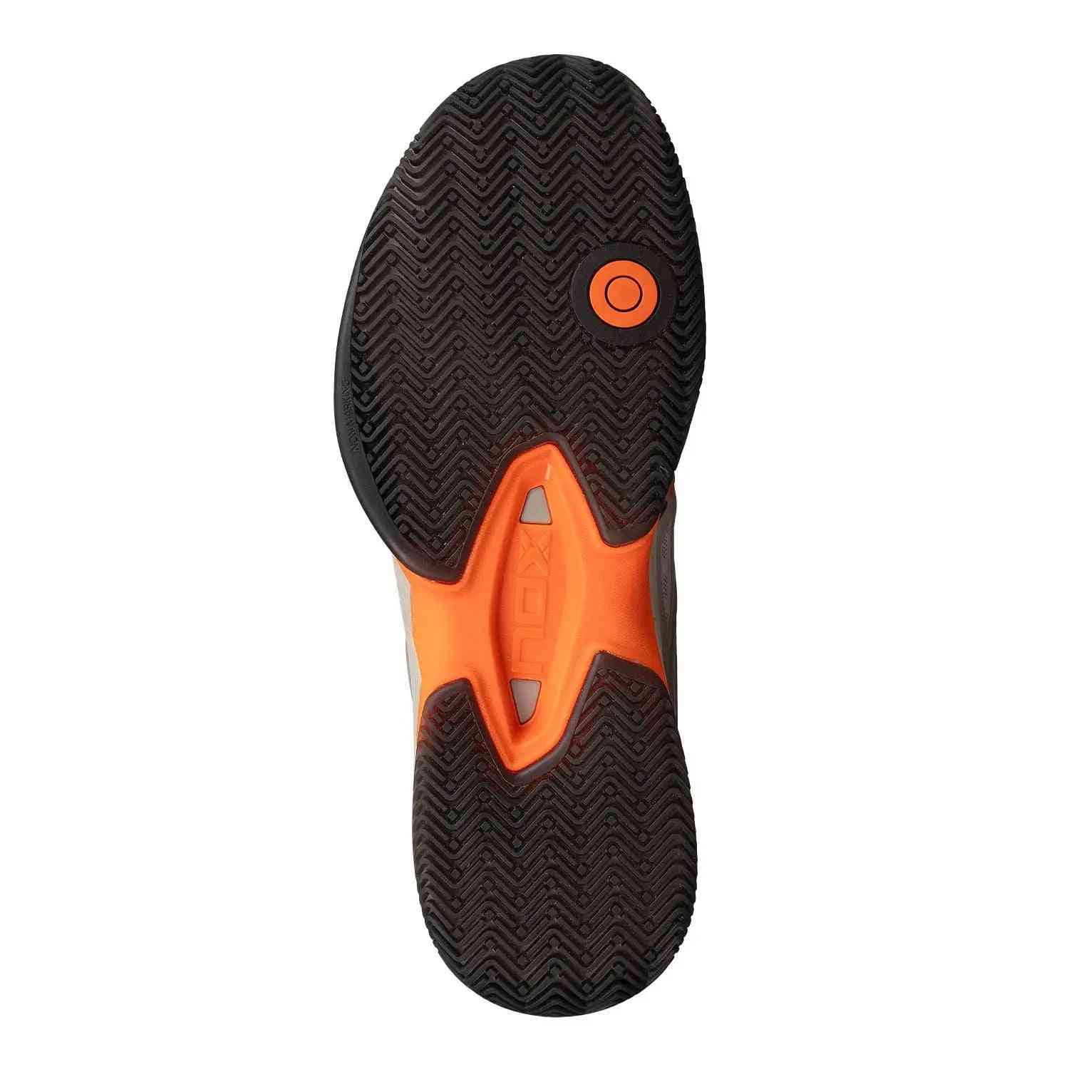 Outsole of Nox AT10 Limited Edition Calat10ltdd Beige featuring herringbone grip pattern and orange stability insert for superior traction on court.