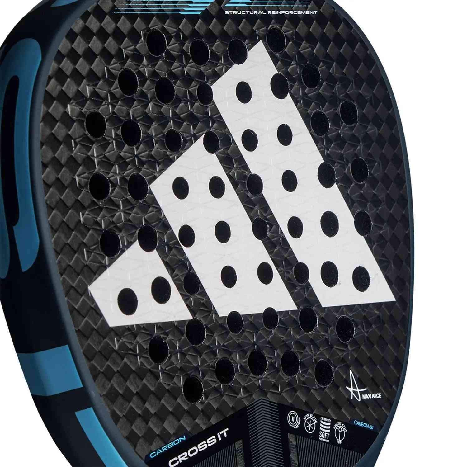 Close-up of Adidas Cross It Carbon Blue by Maxi Arce paddle face with perforated surface and textured Spin Blade technology.