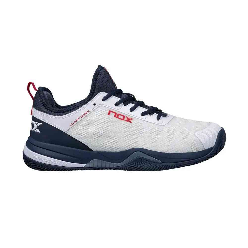Nox Lux Nerbo White Navy Blue Caluxnerwhna athletic shoe with breathable mesh upper and navy sole, ideal for padel performance.